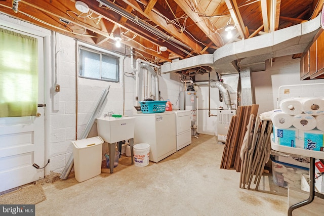 basement featuring heating unit, washing machine and dryer, gas water heater, and a sink