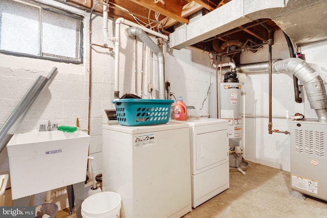 laundry room with gas water heater, washing machine and dryer, laundry area, and a sink