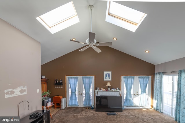 living area with high vaulted ceiling, ceiling fan, and carpet floors