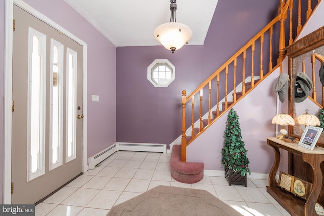 entryway with tile patterned flooring, plenty of natural light, stairway, and baseboards