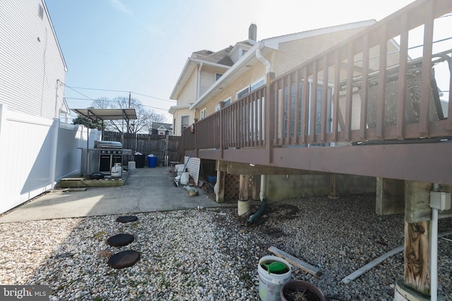 view of home's exterior featuring a patio and fence