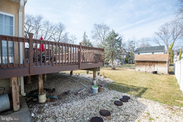 view of yard with an outbuilding, a storage shed, and a deck