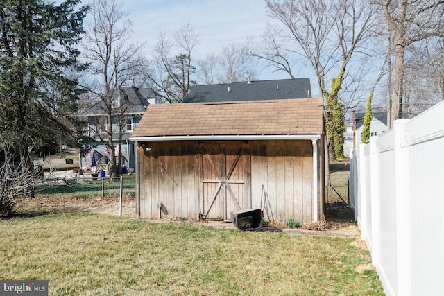 view of shed featuring fence