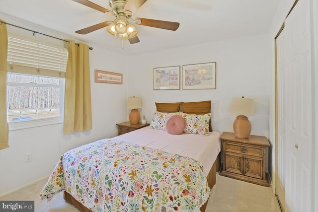 bedroom with a closet, carpet flooring, and a ceiling fan