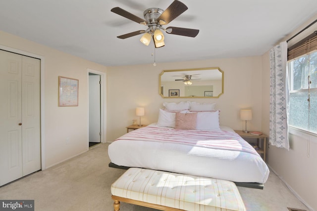 carpeted bedroom with a ceiling fan, baseboards, and a closet