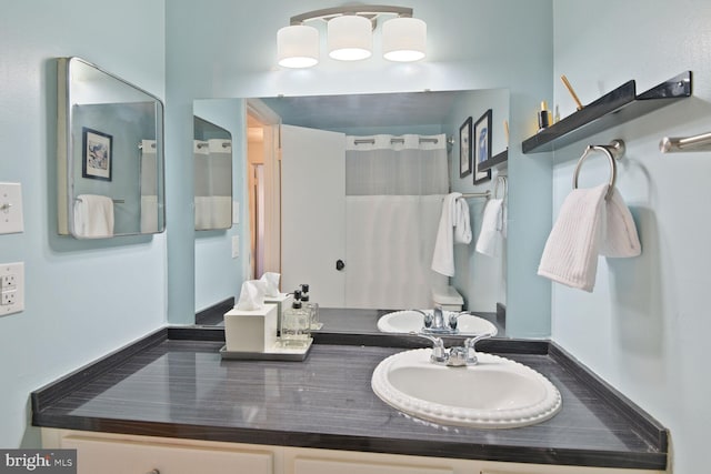 full bathroom with vanity and a shower with shower curtain