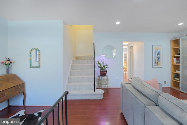 living area featuring stairway, recessed lighting, baseboards, and wood finished floors