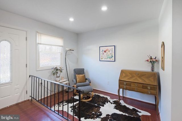 sitting room with recessed lighting, an upstairs landing, and wood finished floors