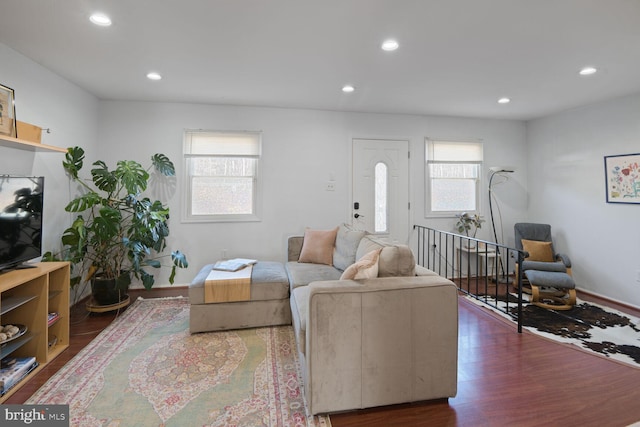 living room featuring recessed lighting, baseboards, and wood finished floors