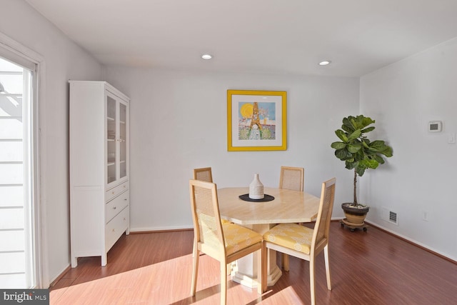 dining room with recessed lighting, visible vents, baseboards, and wood finished floors