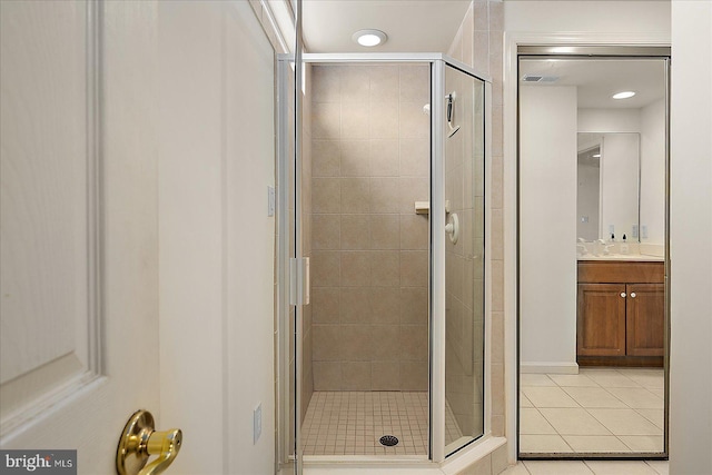 bathroom featuring tile patterned floors, a shower stall, and vanity