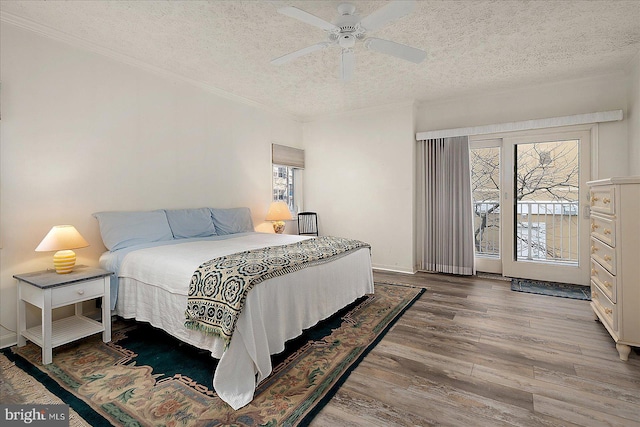 bedroom with crown molding, baseboards, ceiling fan, wood finished floors, and a textured ceiling