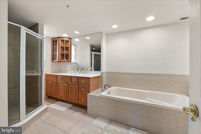 full bath with visible vents, a shower stall, a garden tub, tile patterned floors, and vanity