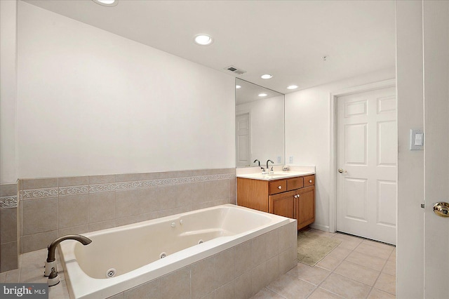 bathroom with visible vents, a jetted tub, recessed lighting, tile patterned flooring, and vanity