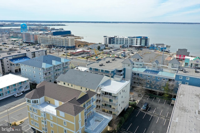 birds eye view of property featuring a water view and a view of city