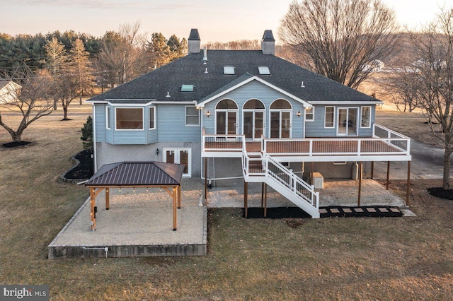 back of house with stairs, a gazebo, a yard, and a patio area