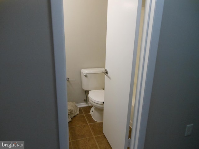 bathroom with tile patterned flooring and toilet