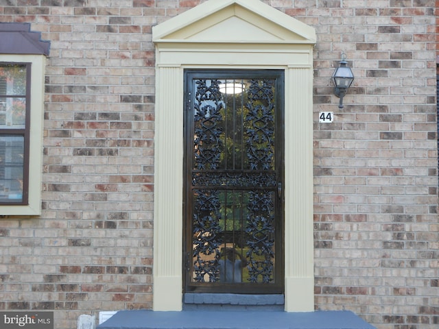 property entrance with brick siding