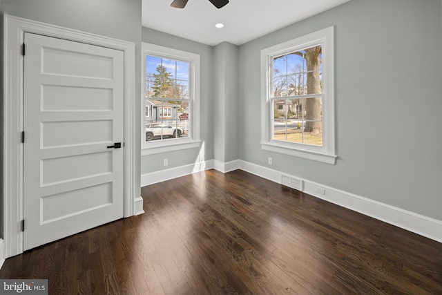 empty room with dark wood-style floors, recessed lighting, a ceiling fan, and baseboards