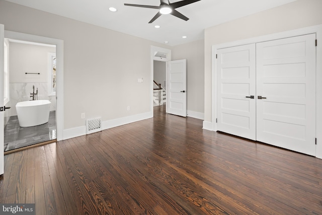 unfurnished bedroom with visible vents, baseboards, dark wood finished floors, recessed lighting, and a closet