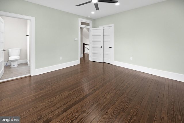 unfurnished bedroom with recessed lighting, baseboards, dark wood-style flooring, and connected bathroom