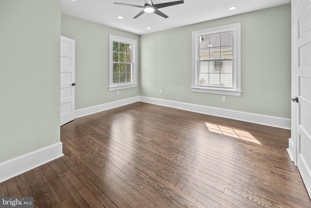 spare room with a ceiling fan, dark wood-type flooring, recessed lighting, and baseboards