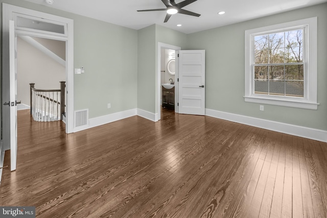 unfurnished bedroom with dark wood-type flooring, baseboards, and visible vents