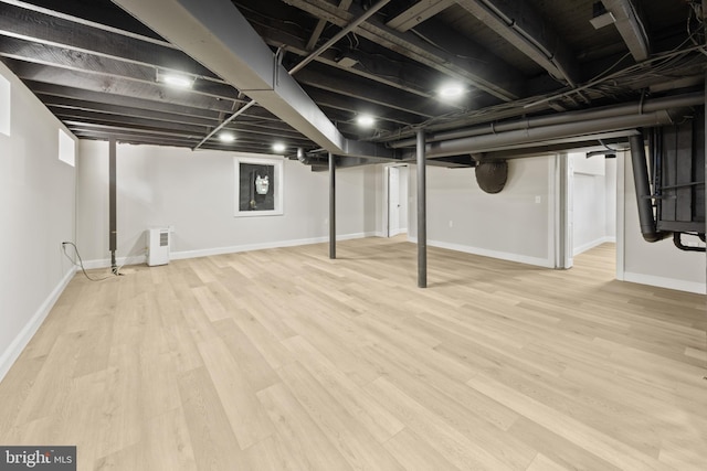 finished basement featuring baseboards and wood finished floors