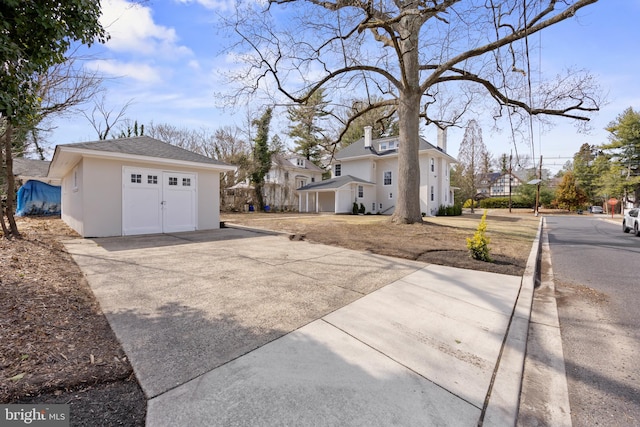 exterior space featuring an outdoor structure, roof with shingles, and stucco siding