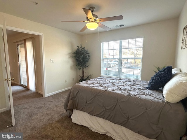 carpeted bedroom with visible vents, a ceiling fan, and baseboards