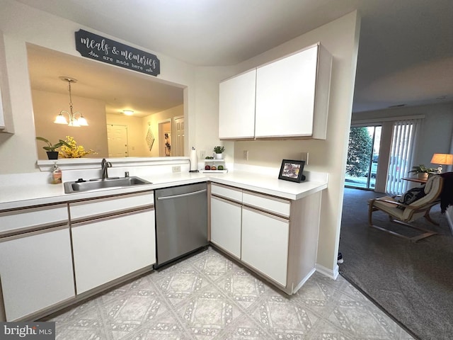 kitchen with light countertops, stainless steel dishwasher, an inviting chandelier, white cabinetry, and a sink