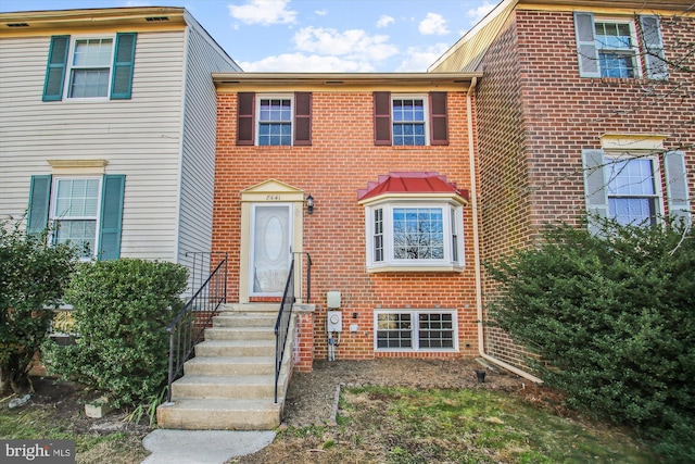 view of property featuring brick siding