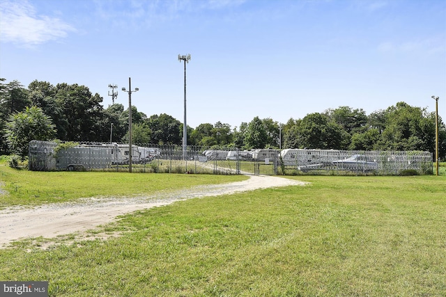 view of property's community with a lawn and fence