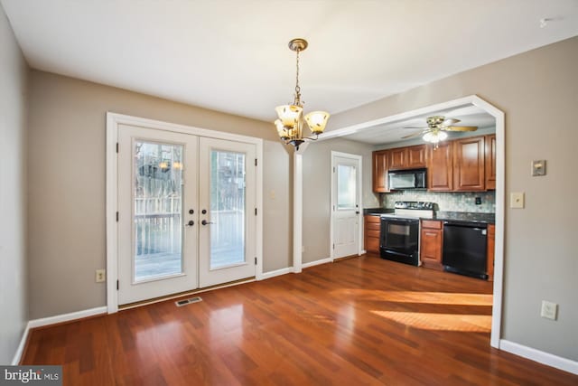 kitchen with black appliances, dark wood-style floors, a healthy amount of sunlight, and visible vents