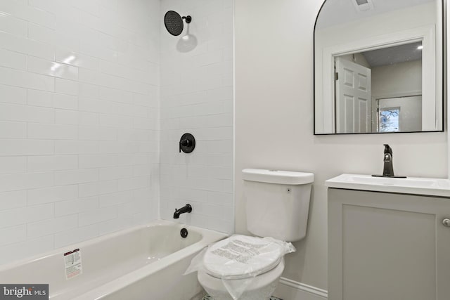 bathroom featuring vanity, toilet, tub / shower combination, and baseboards