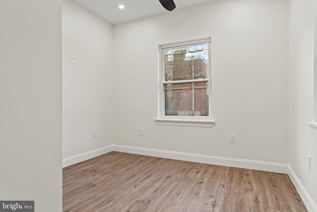 unfurnished room featuring recessed lighting, baseboards, wood finished floors, and ceiling fan