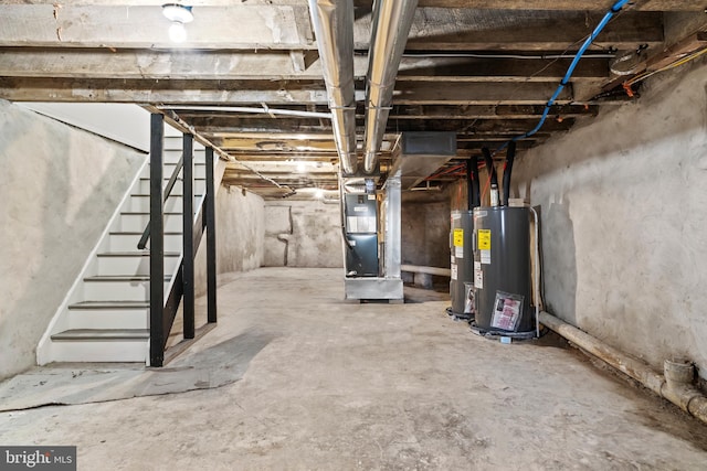 unfinished basement featuring heating unit, stairway, and electric water heater