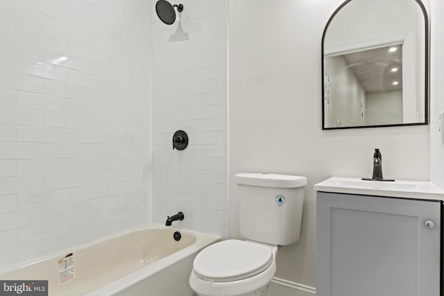 full bath featuring vanity, toilet, washtub / shower combination, and baseboards