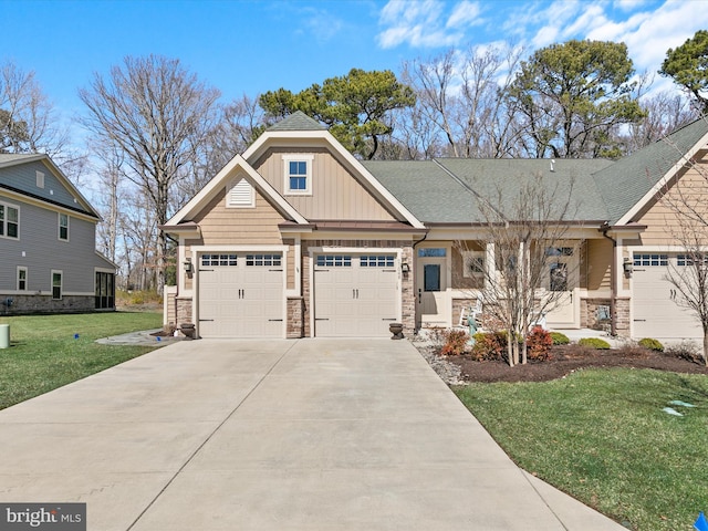 craftsman house with an attached garage, a front lawn, concrete driveway, stone siding, and board and batten siding