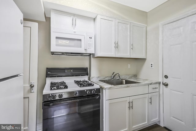 kitchen featuring a sink, white appliances, and white cabinets