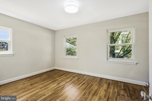 unfurnished room featuring baseboards and wood finished floors