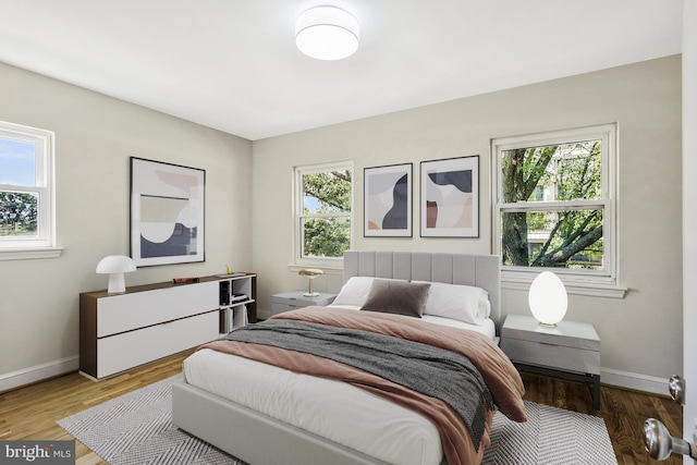 bedroom with wood finished floors and baseboards