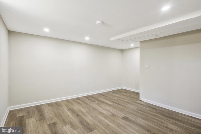 finished below grade area featuring recessed lighting, baseboards, and light wood-style flooring