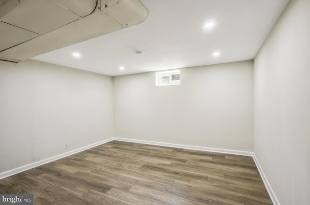 basement featuring recessed lighting, visible vents, baseboards, and wood finished floors