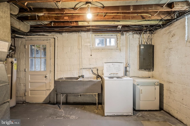 basement featuring gas water heater, electric panel, separate washer and dryer, and a sink