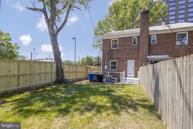 view of yard with cooling unit and a fenced backyard