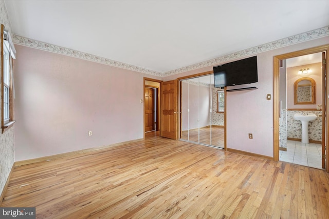 interior space featuring wallpapered walls and light wood-style floors