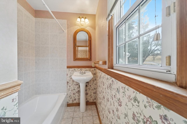 bathroom featuring tile patterned flooring, shower / bathing tub combination, a wainscoted wall, and a sink