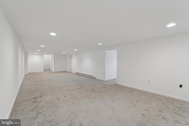 carpeted empty room featuring recessed lighting, baseboards, and baseboard heating