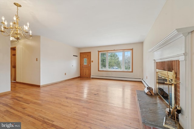 unfurnished living room featuring a baseboard heating unit, baseboards, a chandelier, and light wood finished floors